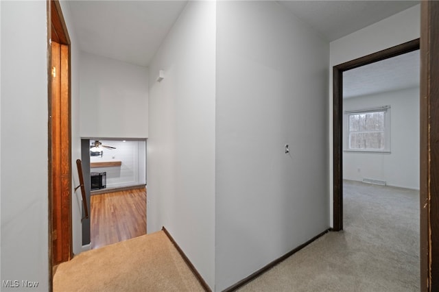 hallway with light colored carpet