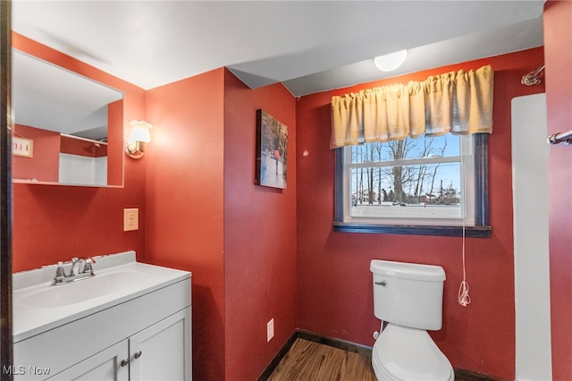 bathroom featuring hardwood / wood-style flooring, vanity, and toilet