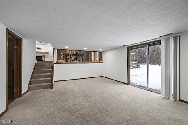 basement featuring carpet flooring and a textured ceiling