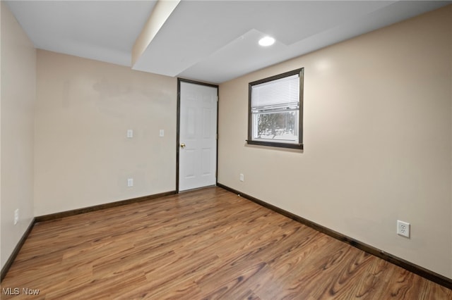 unfurnished room with light wood-type flooring