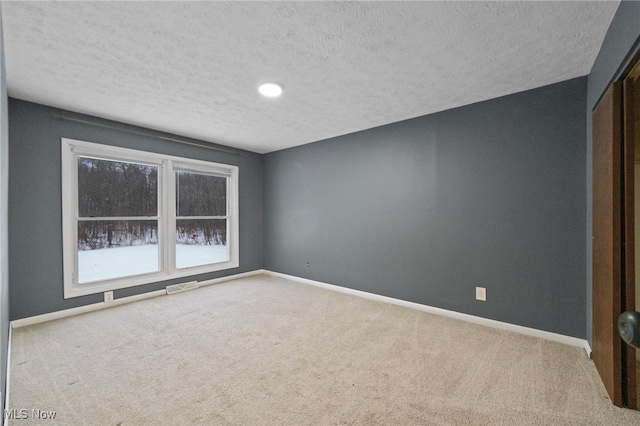 unfurnished bedroom with carpet flooring, a closet, and a textured ceiling