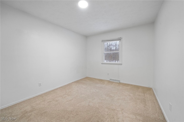 empty room with light colored carpet