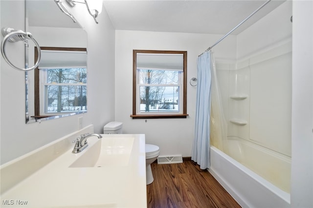 full bathroom with wood-type flooring, vanity, toilet, and shower / bathtub combination with curtain