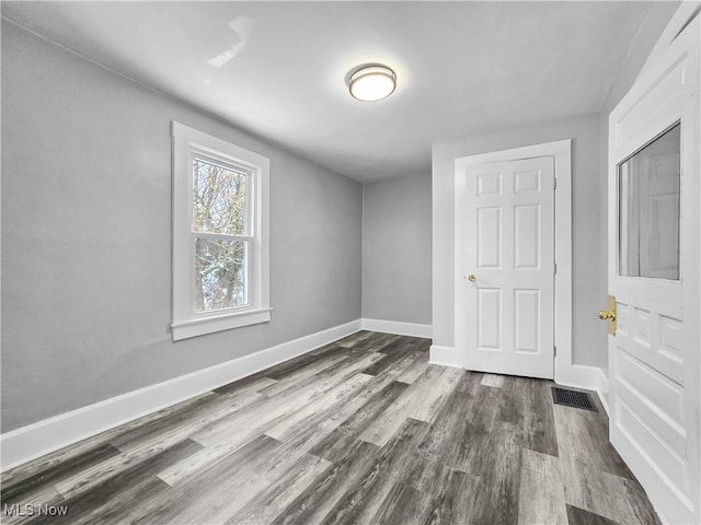 unfurnished room featuring dark wood-type flooring