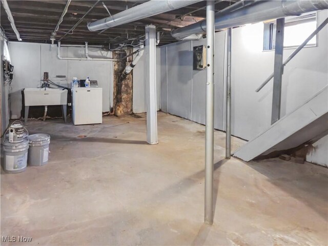 basement featuring washer / dryer and sink