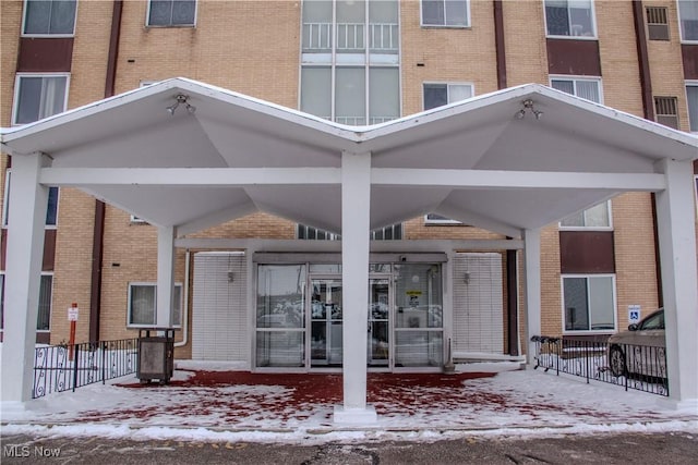 view of snow covered property entrance