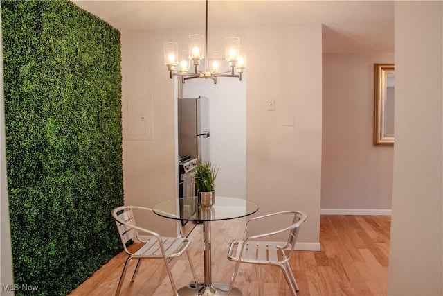 dining room featuring light hardwood / wood-style floors and an inviting chandelier