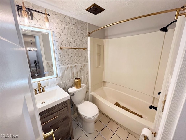 full bathroom with vanity, shower / tub combination, tile walls, tile patterned flooring, and toilet