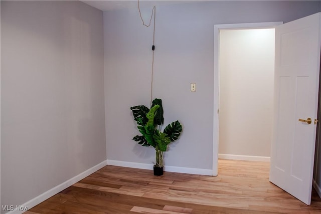 empty room with light hardwood / wood-style flooring