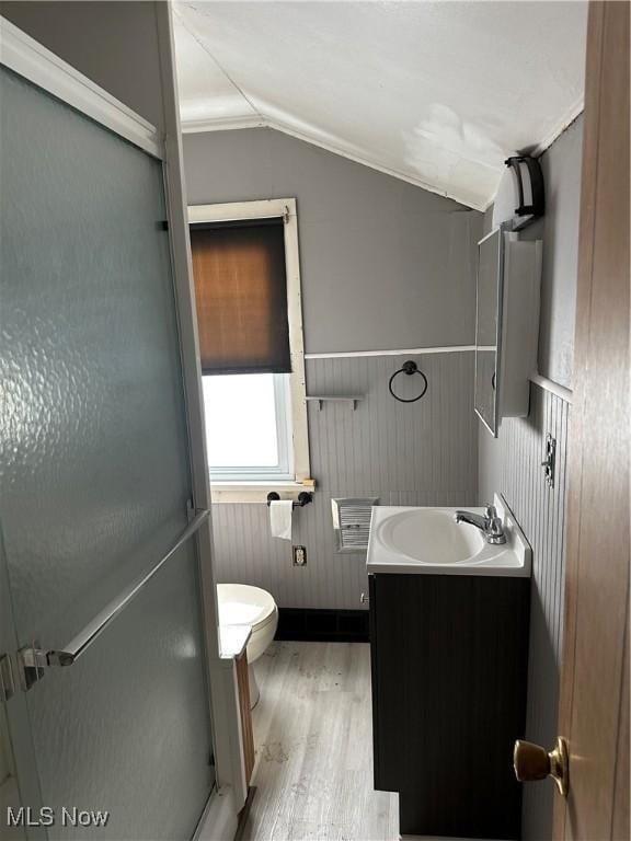 bathroom with crown molding, lofted ceiling, an enclosed shower, toilet, and vanity