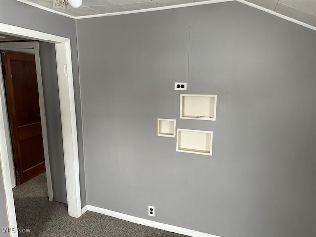 spare room with dark carpet