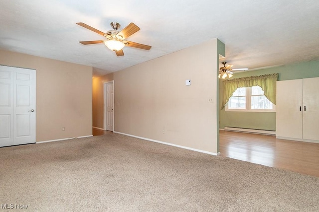 carpeted empty room featuring ceiling fan and a baseboard heating unit