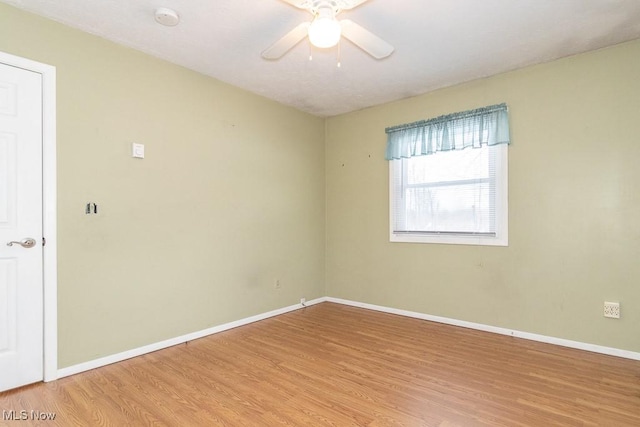 empty room featuring ceiling fan and light hardwood / wood-style floors