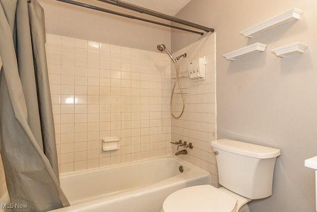 bathroom featuring shower / bath combo and toilet