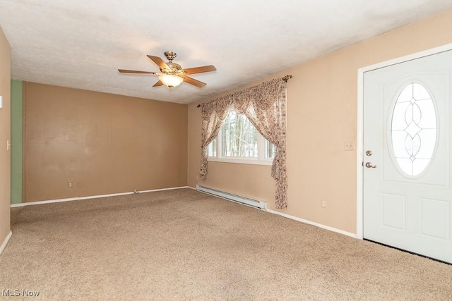 carpeted foyer entrance with ceiling fan and a baseboard heating unit