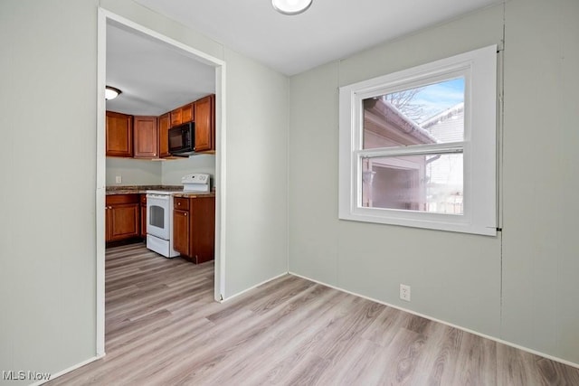 kitchen with light wood-type flooring and white range with electric stovetop