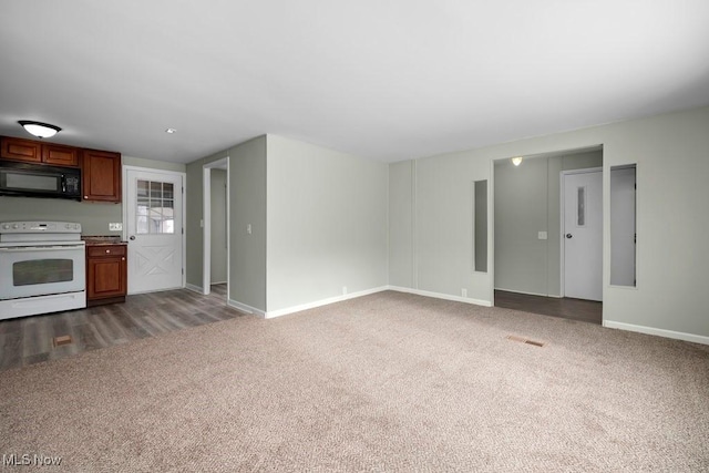 unfurnished living room featuring dark carpet