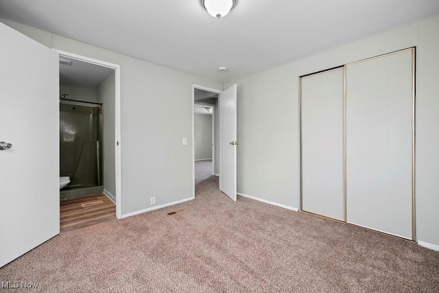 unfurnished bedroom with connected bathroom, carpet floors, and a closet