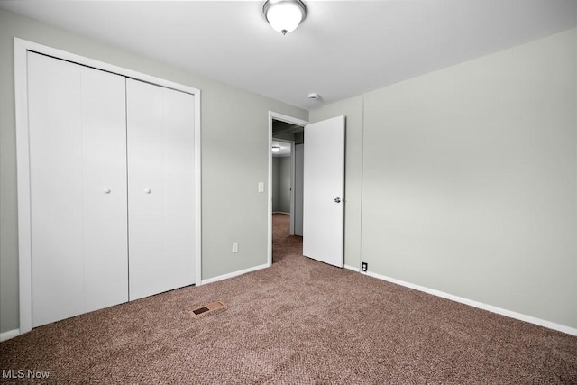 unfurnished bedroom with a closet and carpet