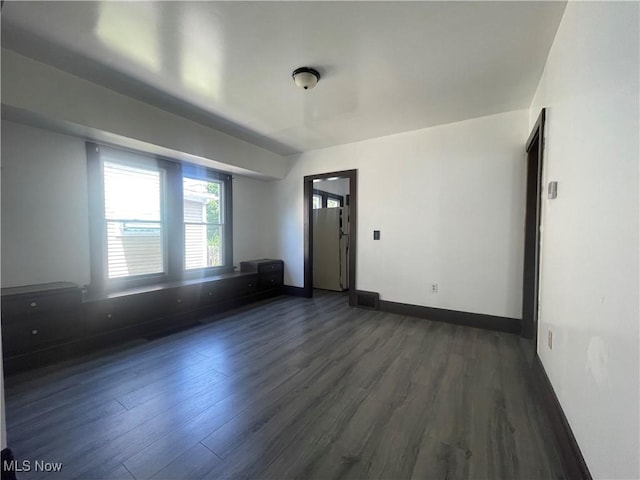 unfurnished room featuring dark hardwood / wood-style floors