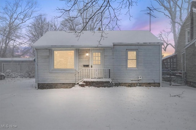 view of snow covered rear of property