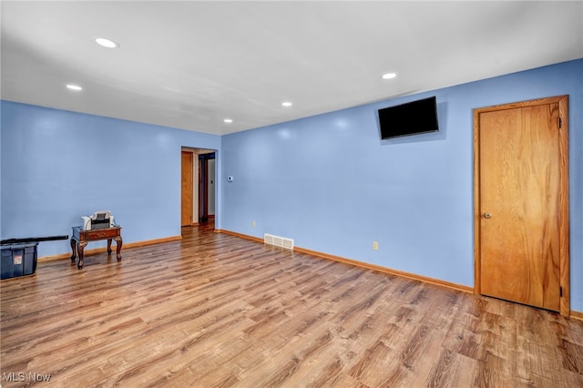 unfurnished room with light hardwood / wood-style floors