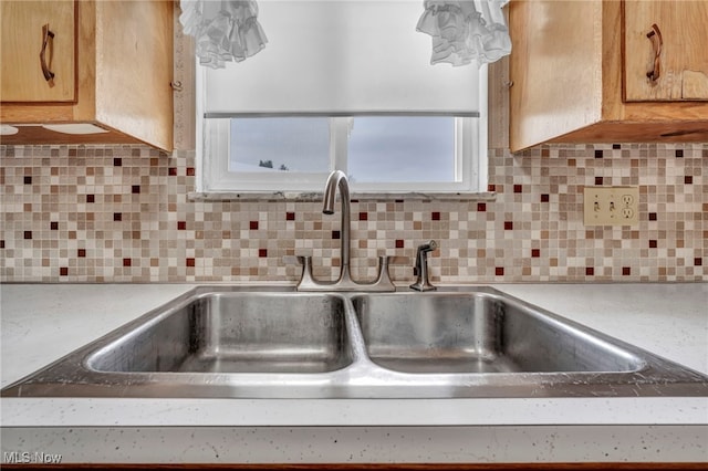 kitchen featuring backsplash and sink