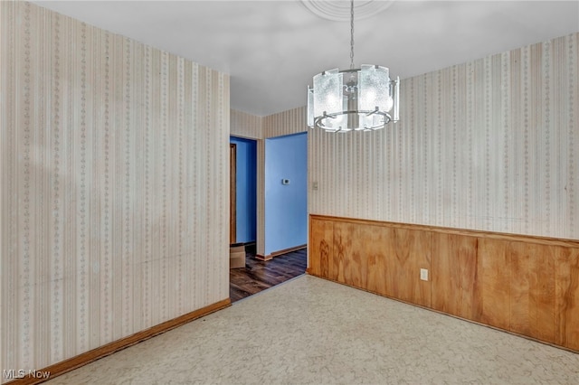 spare room featuring a chandelier