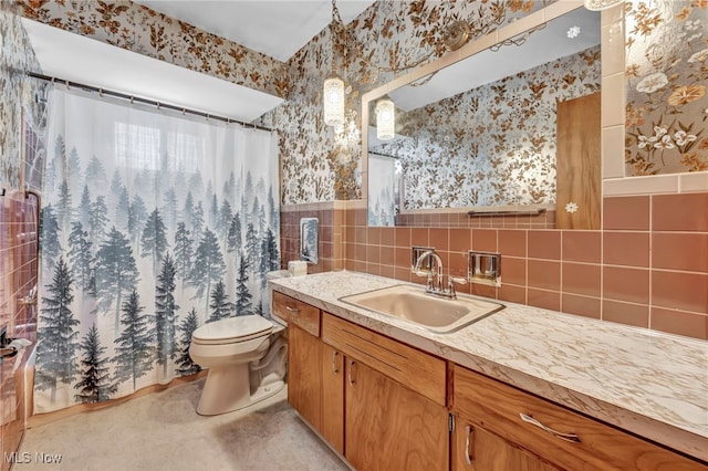 bathroom with walk in shower, vanity, and toilet