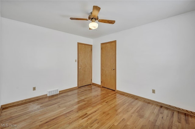 empty room featuring ceiling fan and light hardwood / wood-style flooring