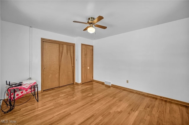 bedroom with ceiling fan and light wood-type flooring