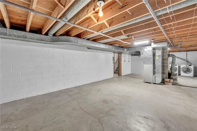 basement with washing machine and dryer and heating unit