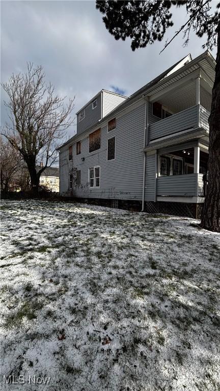 snow covered property with a balcony