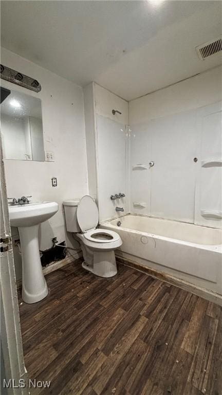 full bathroom with sink, wood-type flooring, bathtub / shower combination, and toilet