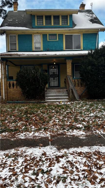 view of property featuring covered porch