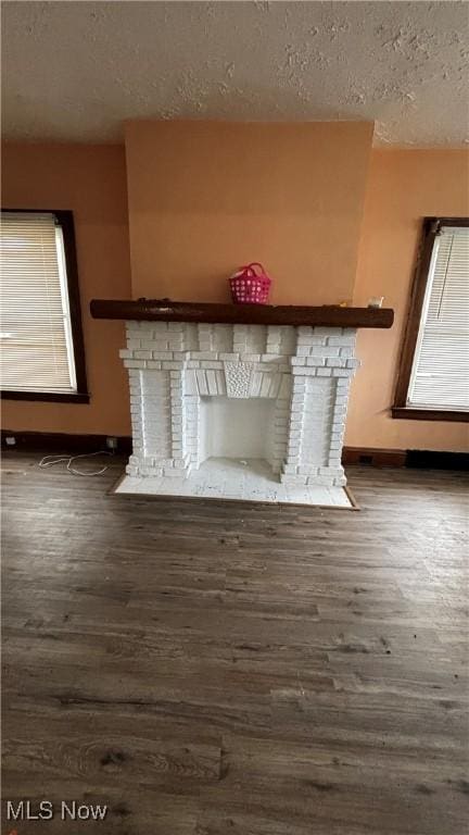 interior details featuring a fireplace, hardwood / wood-style floors, and a textured ceiling