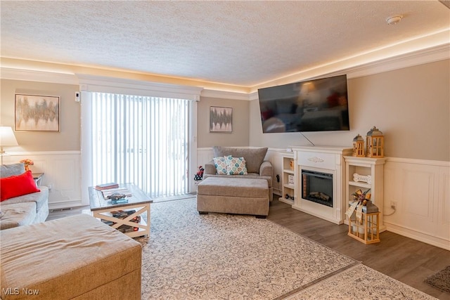 living room featuring dark wood-type flooring and a textured ceiling