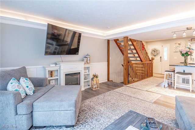 living room with hardwood / wood-style floors and a textured ceiling