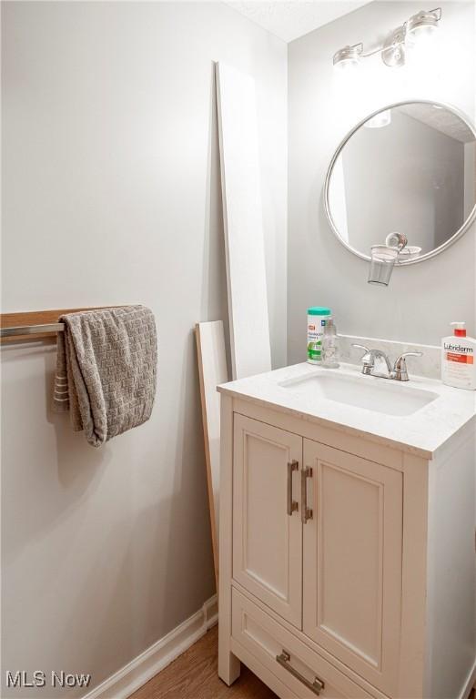 bathroom featuring hardwood / wood-style floors and vanity