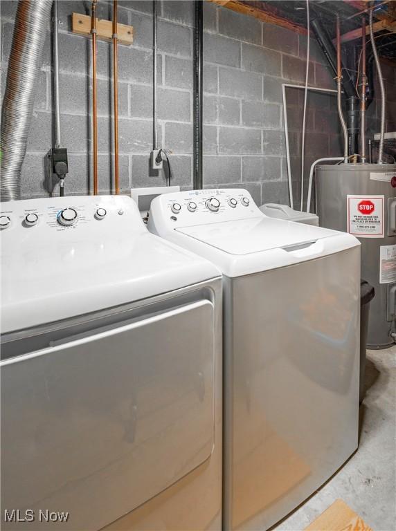 clothes washing area with washing machine and dryer and electric water heater