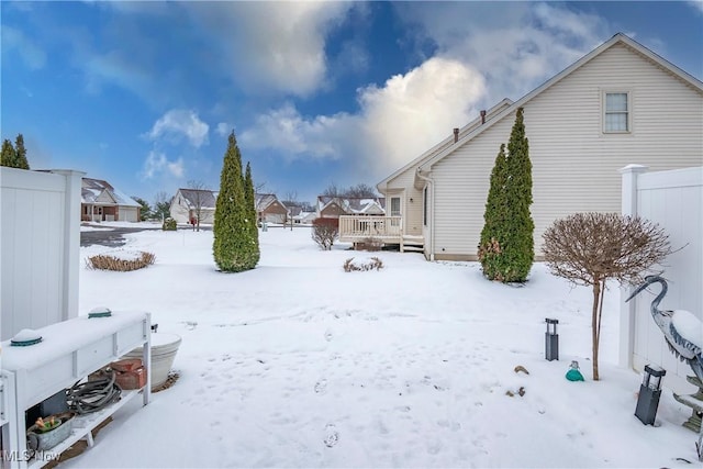 snowy yard with a deck