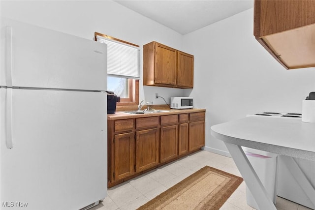 kitchen with white appliances and sink