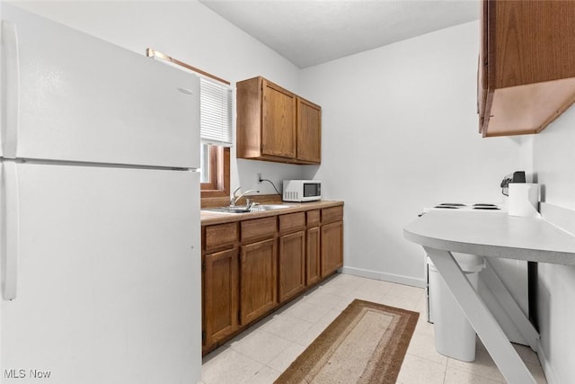 kitchen featuring sink and white appliances