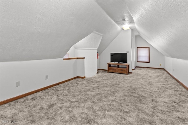 bonus room featuring light carpet, a textured ceiling, and vaulted ceiling