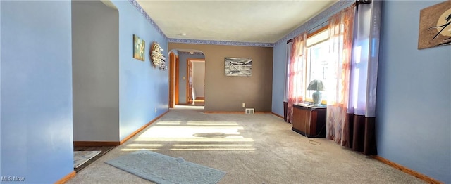 hall with light colored carpet