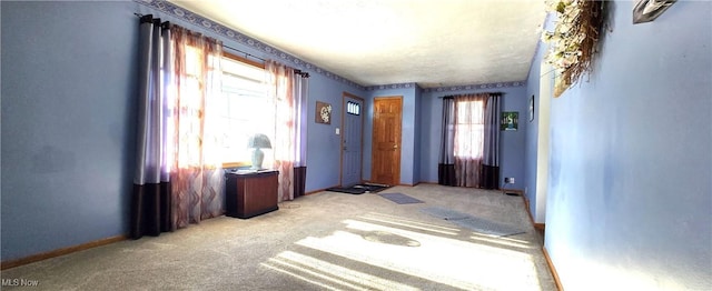 interior space featuring light carpet and a wealth of natural light