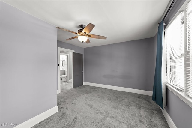 carpeted empty room featuring ceiling fan