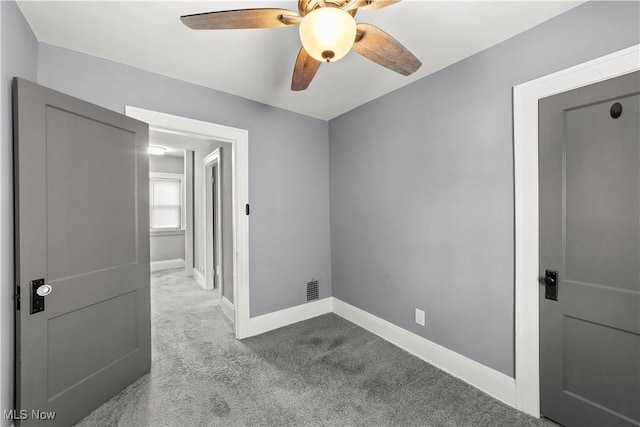 unfurnished room with ceiling fan and light carpet