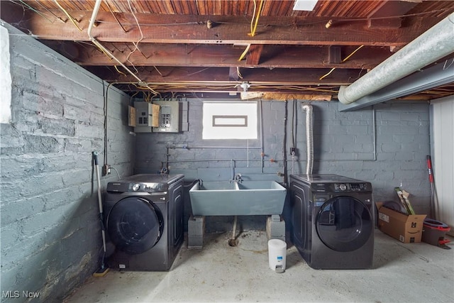 basement featuring electric panel and washer and dryer