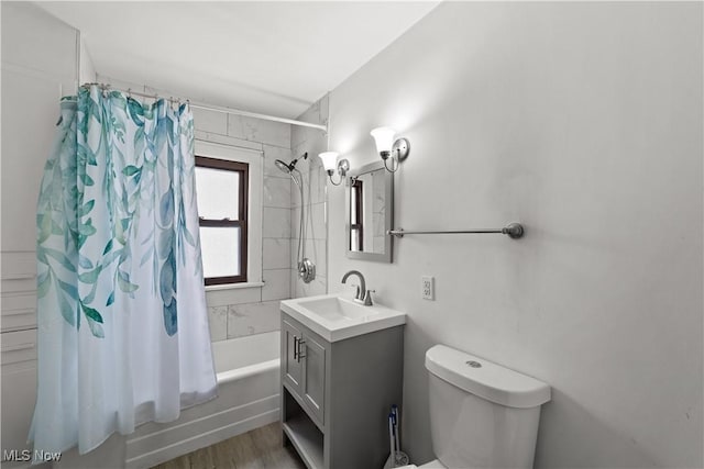 full bathroom featuring hardwood / wood-style floors, shower / bath combination with curtain, toilet, and vanity